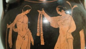 Pelike. A woman holding a spray hands