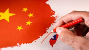Hand drawing a red line between Taiwan isle and Mainland China.